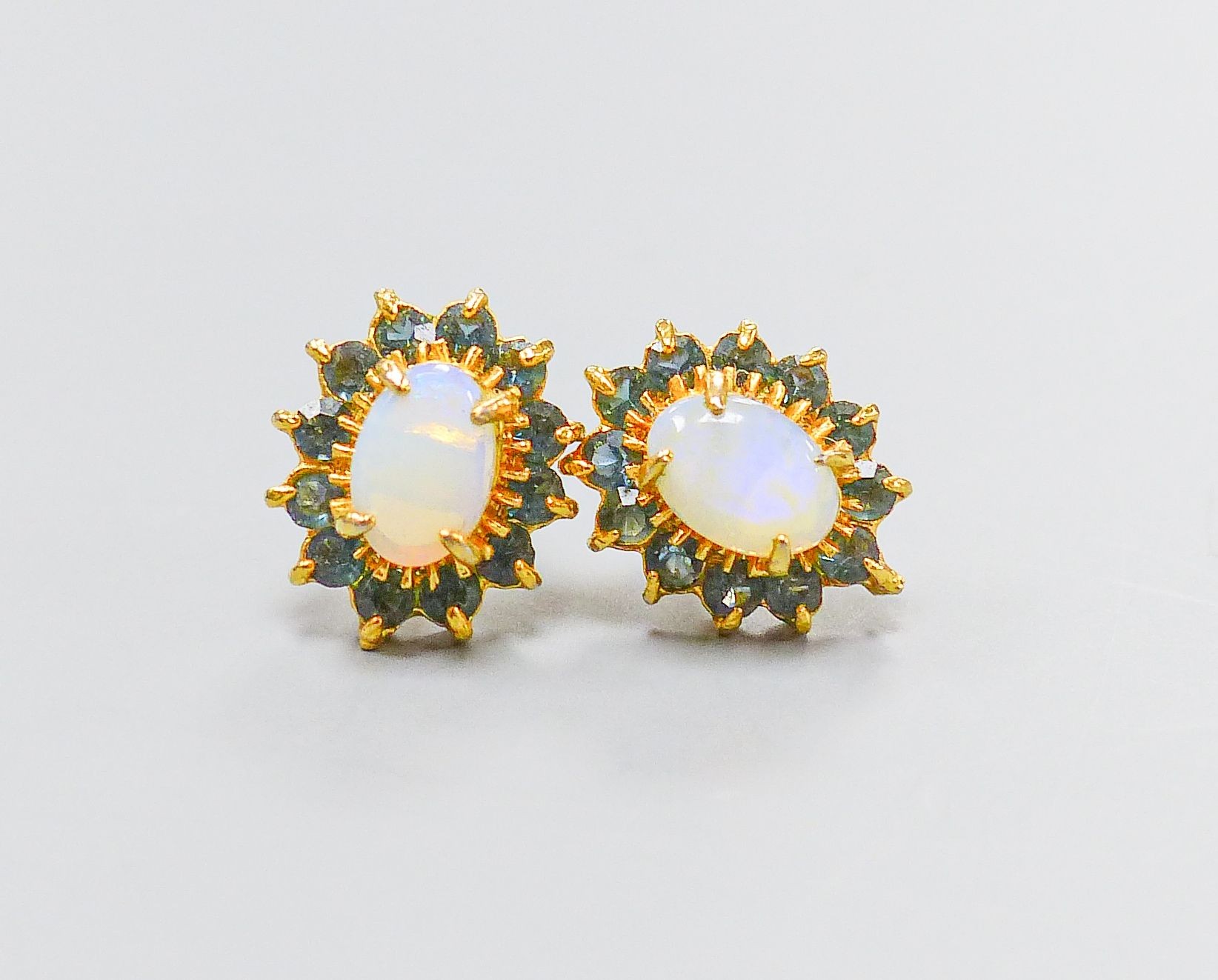 A pair of yellow metal, opal and sapphire oval cluster set ear studs(no butterflies), 10mm, gross 1.4 grams.